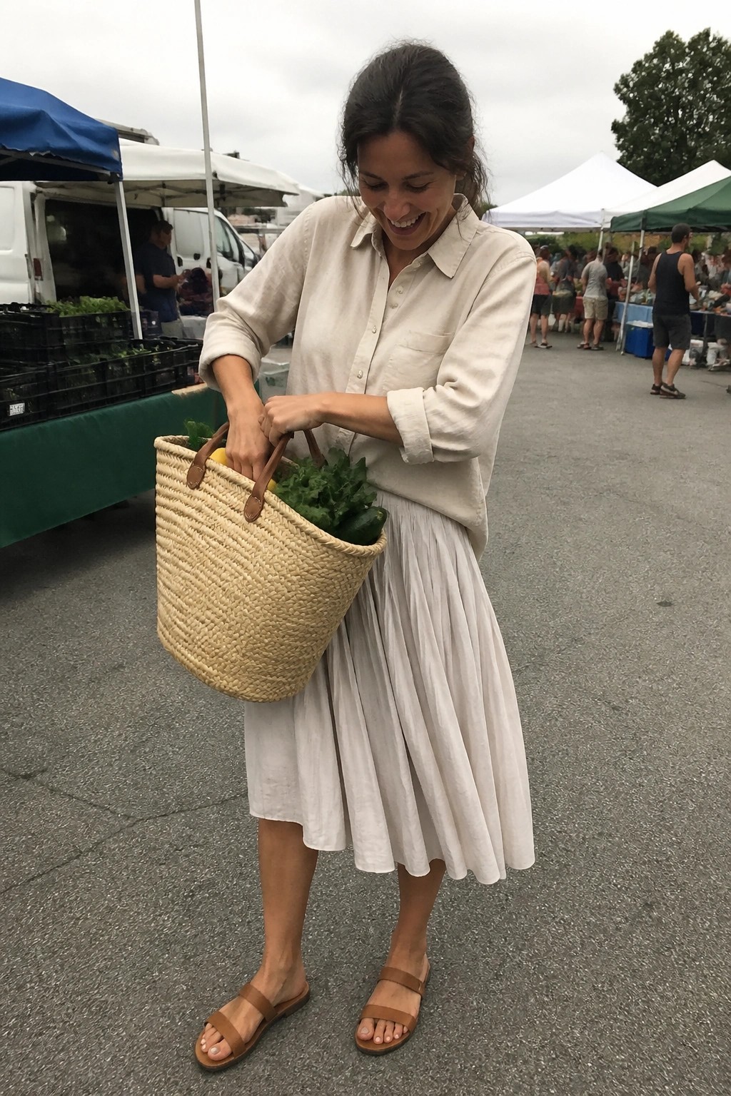 Woman in beige shirt and white skirt holding woven basket at market