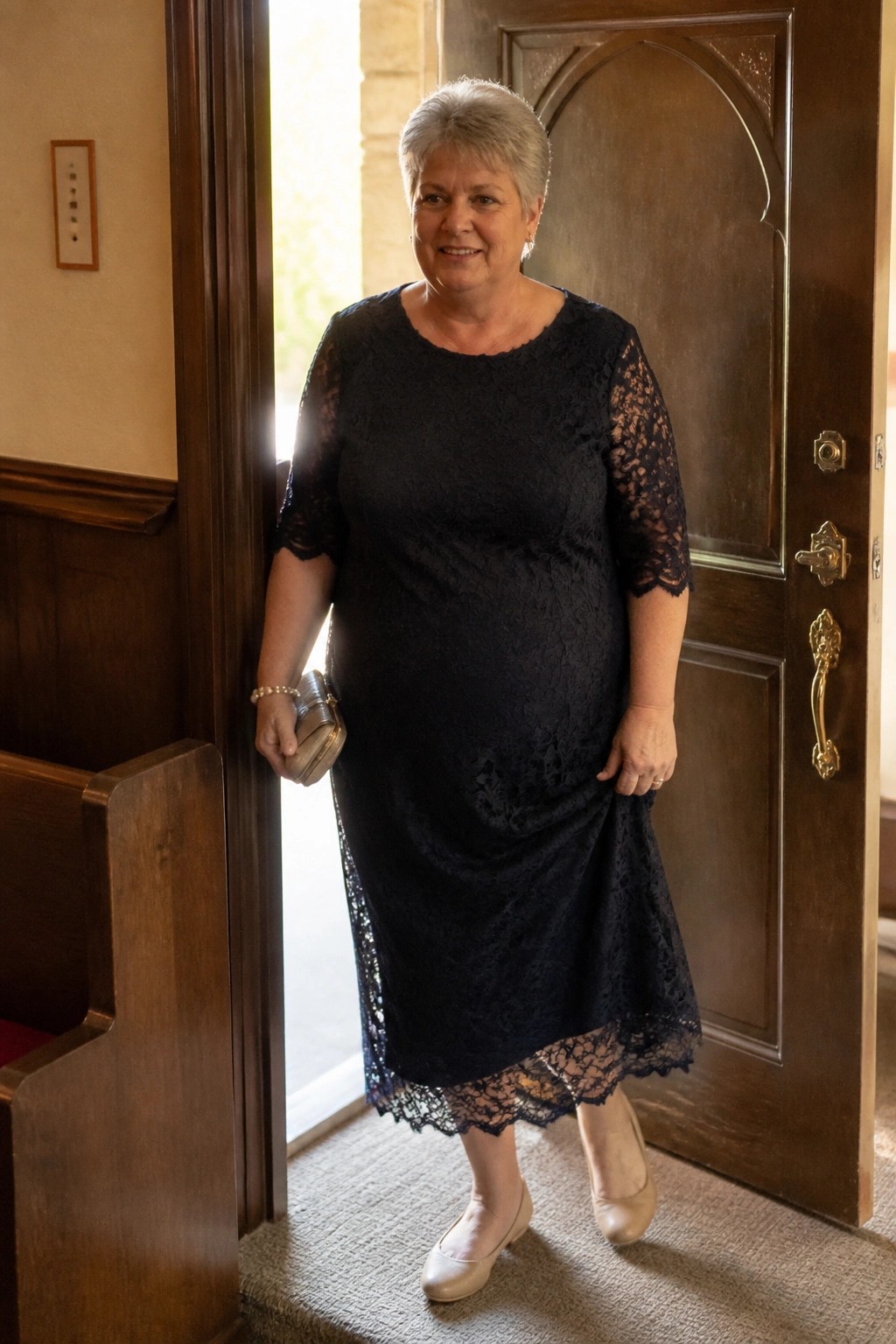 Woman in black lace dress holding purse in open church doorway.